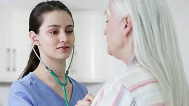 Woman Having Health Check With Female Doctor In Surgery