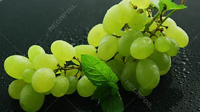 Green grapes on wet table