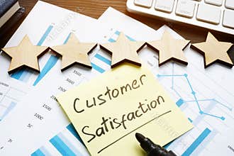 Five stars and customer satisfaction. Documents on a desk