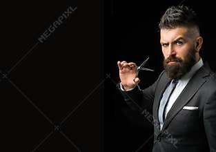 Confident barber at barbershop. Barber and hairdresser salon. Beard care, perfect beard. Bearded man in formal business