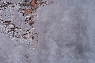 Textured wall with fragments of old red bricks