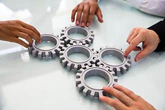 Business People`s Hand Connecting Gears
