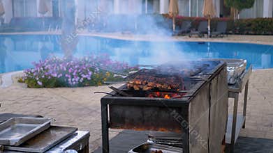 Chicken Barbecue are Cooked on a Large Grill by a Cook at the Hotel by the Pool with Blue Water. Egypt
