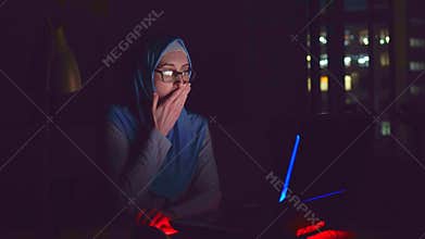 Muslim girl with glasses and a hijab for a laptop saw a shocking and scary content