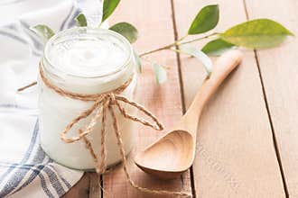 Yogurt in glass bottles on wooden table