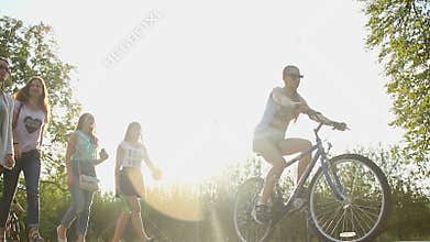 Group of female students strolling in municipal park, enjoying summer holidays