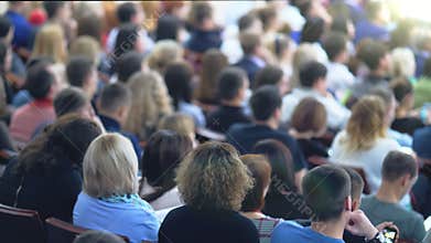 Speaker giving a talk in conference hall at business event. Audience at the conference hall.