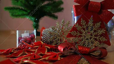 Composition design. Christmas Ball, Ribbon Bows, Plastic Glitter Christmas Snowflakes Ornaments. Mans Hand Decorating