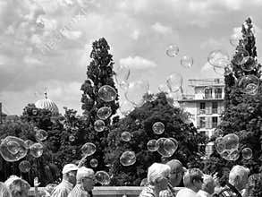 People walking with bubbles floating above their heads. Berlin, Mitte.