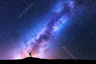 Milky Way and silhouette of happy woman. Space