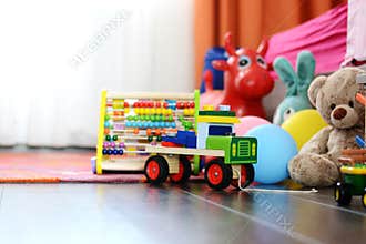 Childrenâ€™s multicolored toys on wooden floor or carpet on kids room