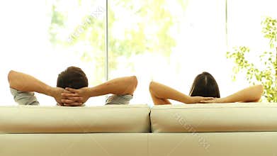 Couple relaxing on a couch at home