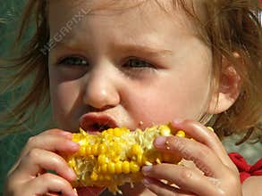 Girl eating corn on the cob