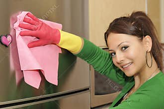 smiling girl cleaning the house - refrigerator