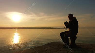 Landscape photographer taking a pictures of sunset