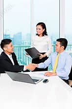 Asian banker counseling man in office