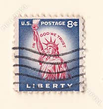 An old blue vintage american postage stamp with the statue of liberty in Manhattan