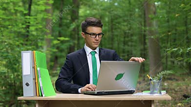 Successful businessman relaxing outdoors after hardworking, eco-friendly office
