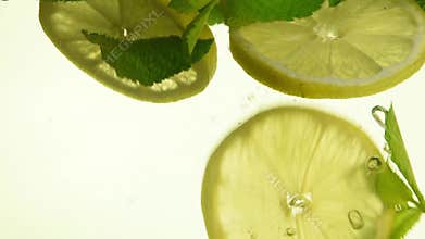 Close up green mint leaves and lemon in mojito