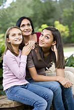 Affectionate mother and two daughters smiling