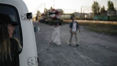 The scene of the scared girl runs away from the zombie, hiding behind the white van then run away. Two creepy zombies