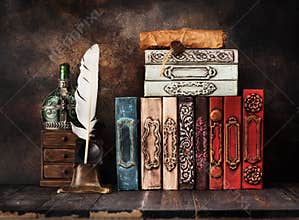 Ancient books, vintage bottles, manuscript with a wax seal and bronze inkwell