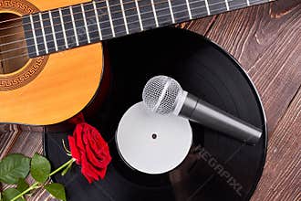 Guitar, vinyl record, microphone and rose.