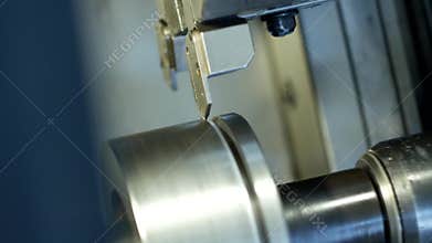 CNC lathe pulls out part of metal workpiece pulley, modern lathe for metal processing, close-up, machine