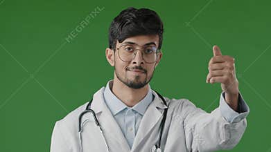 Indian professional male doctor arabian man doctor intern in white medical uniform stands in green studio make welcome