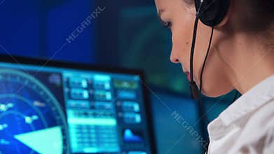 Workplace of the professional air traffic controller in the control tower. Female aircraft control officer works using