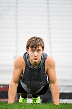 Male Teenager Doing Push Ups, Empty Bleachers
