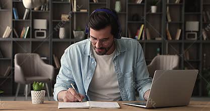 Happy young man in headphones holding zoom video call.
