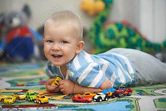 Casual portrait of a toddler playing with toy cars
