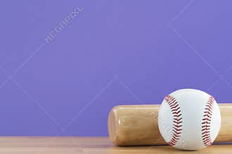 Baseball and baseball bat on wooden table with purple copy space background, sport concept