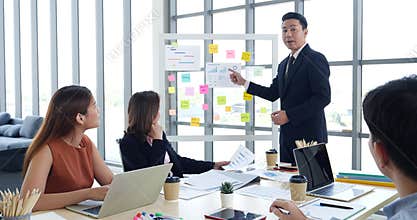 Happy business people meeting present graph chart investment, business data in meeting room. Group of business people meeting in c