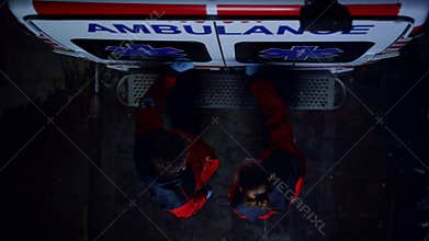 Paramedics closing doors of ambulance car. Emergency doctors finishing work