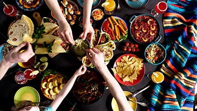 Mexican family celebrates Cinco de mayo. Traditional Mexican cuisine on the table. Guacamole: A Classic Mexican Dish