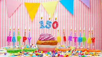 Happy birthday number 150. On a pink background, congratulations on the birthday of one hundred and fifty years old. Muffins