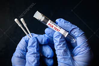 COVID-19 swab collection kit in doctor hands, nurse holds tube of coronavirus PCR test