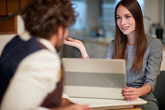 Male and female work colleagues consulting