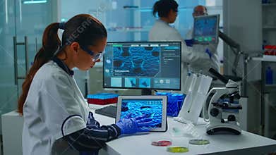 Lab technician doctor analyzing virus evolution looking on digital tablet