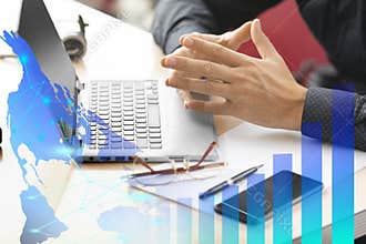 E-business concept - businessman hands in front of laptop monitor, growth charts and virtual analytics.