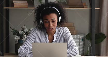 Busy focused young african woman holding video call.
