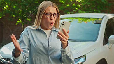 Caucasian woman businesswoman using mobile phone smartphone message notification good news enjoy victory winning success