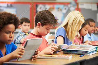 Pupils In Class Using Digital Tablet