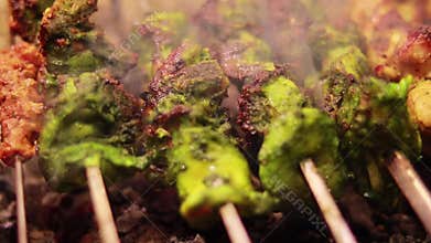 Closeup shot of Kebabs being prepared at a restaurant, Juicy seekh kebab on skewers