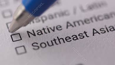 Pen mark a Checkbox labeled &#x27;Native American&#x27; on a document.