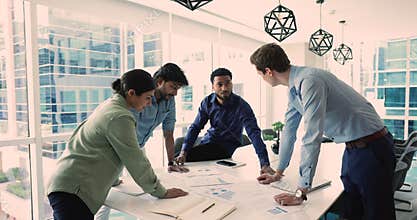Serious teammates review sales statistics shown in graphs and charts