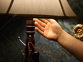 Hand turning off light