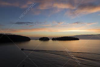 Silhouettes of islands and boats in the morning sky